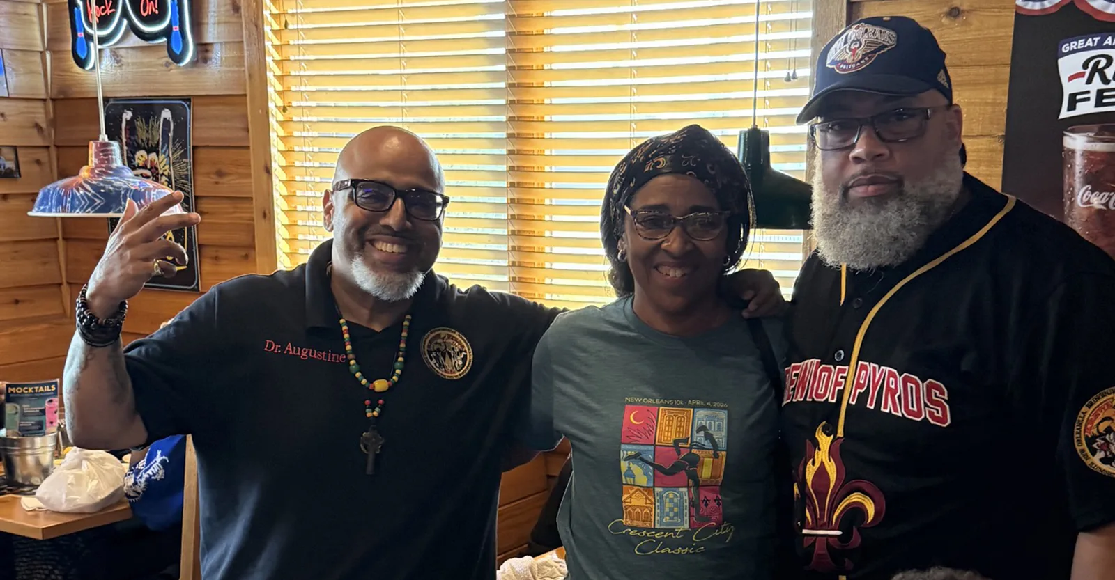 Dr. Augustine and two Krewe of Pyros members at a Dine to Donate restaurant fundraiser