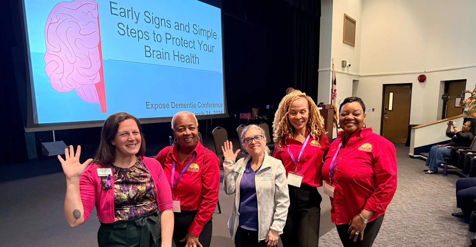 Members and presenters beside a brain health slide at the Expose Dementia Conference