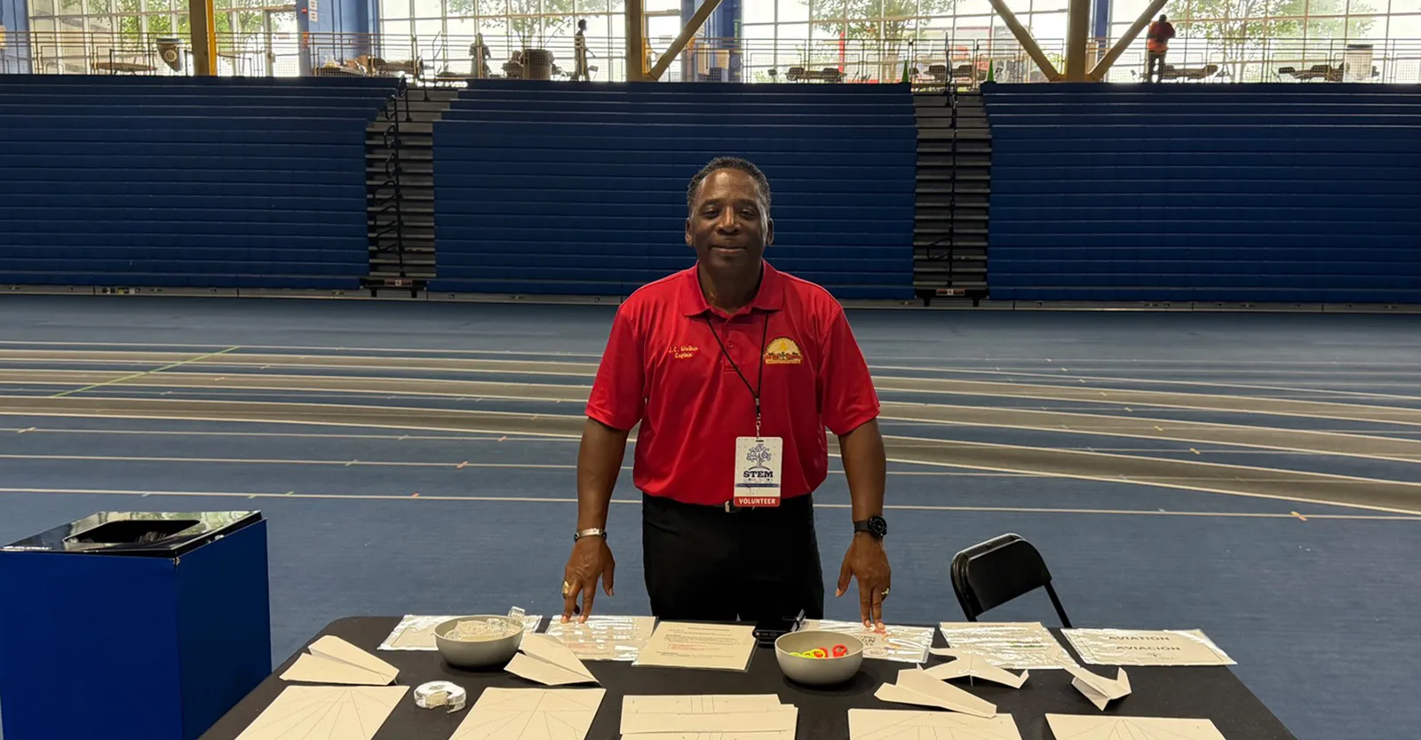 Captain J.C. Walker volunteering at a STEM aviation activity station