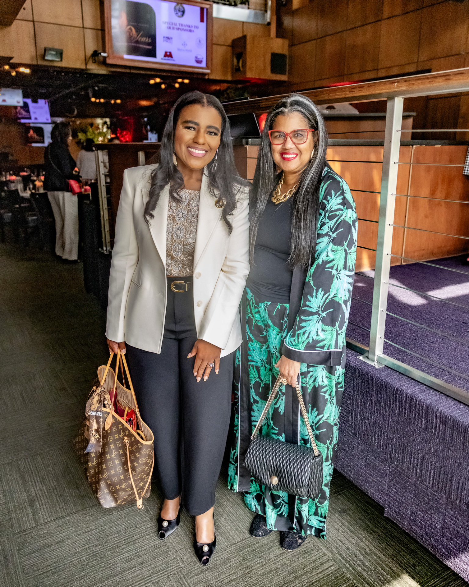 Two guests posing together at the Krewe of Pyros Fundraising Brunch