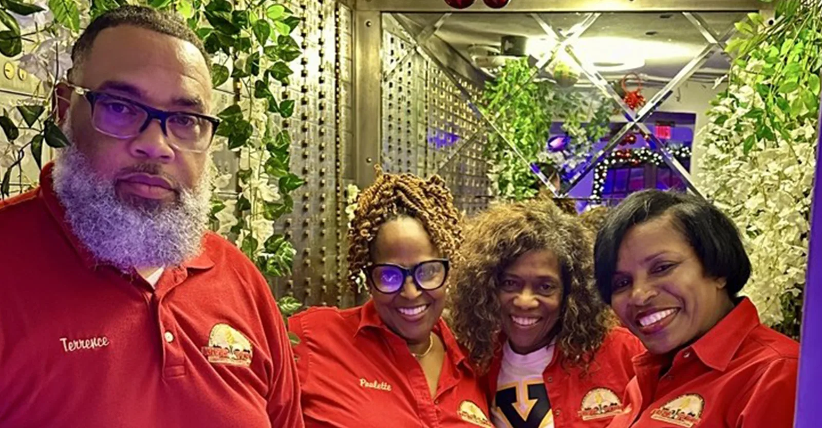 Four Krewe members in red shirts at a holiday Dine to Donate gathering