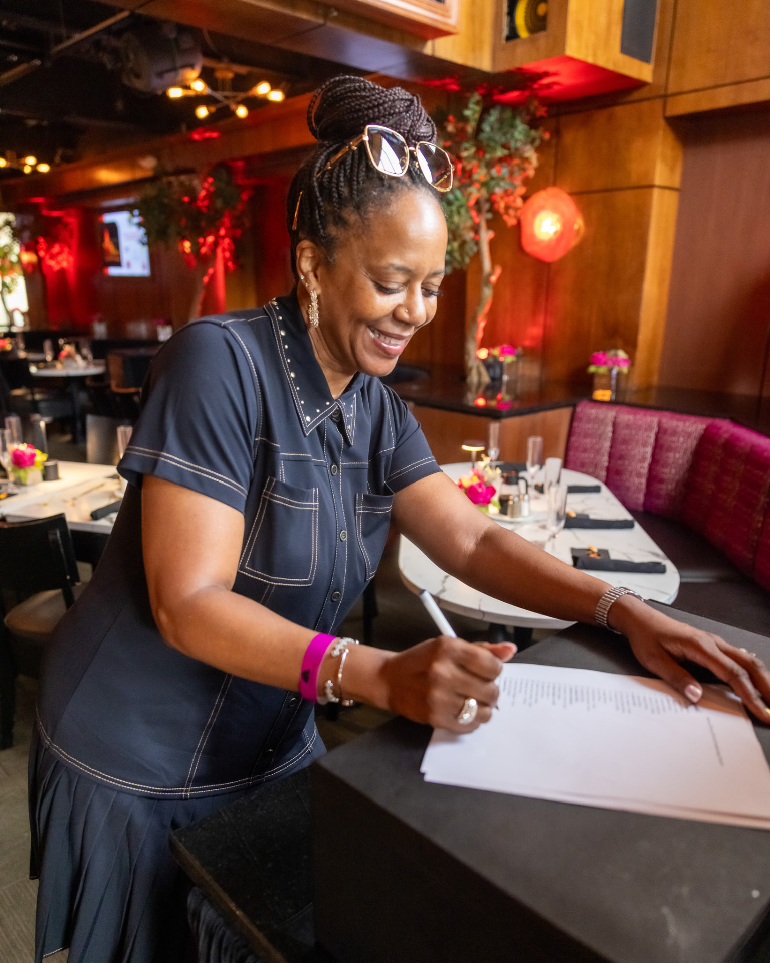Krewe of Pyros volunteer signing in guests at the brunch check-in table