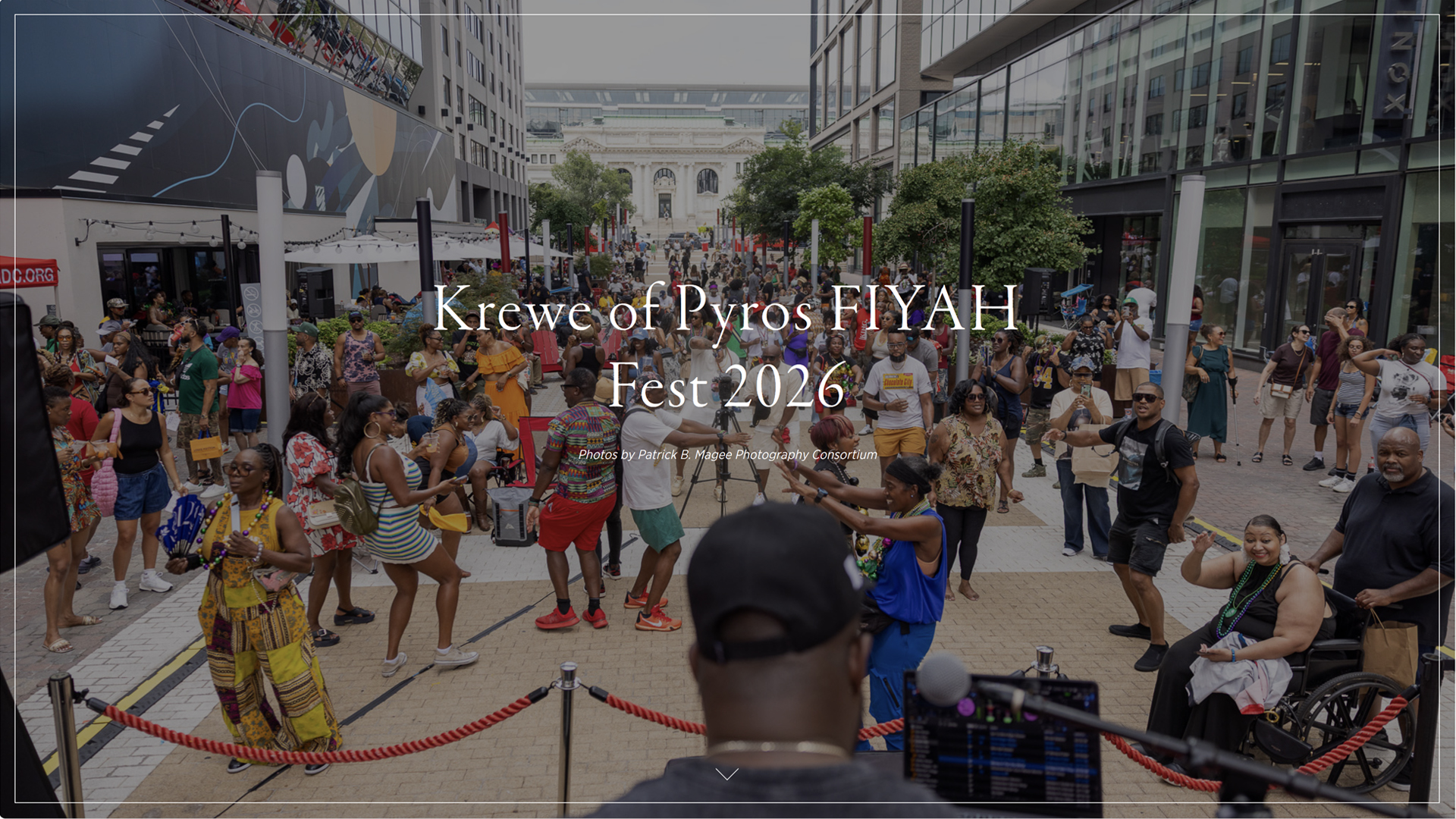 Crowd dancing in the street at Krewe of Pyros FIYAH Fest 2026 in downtown Washington, DC, with beads, brass-band energy and a DJ at the front of the stage