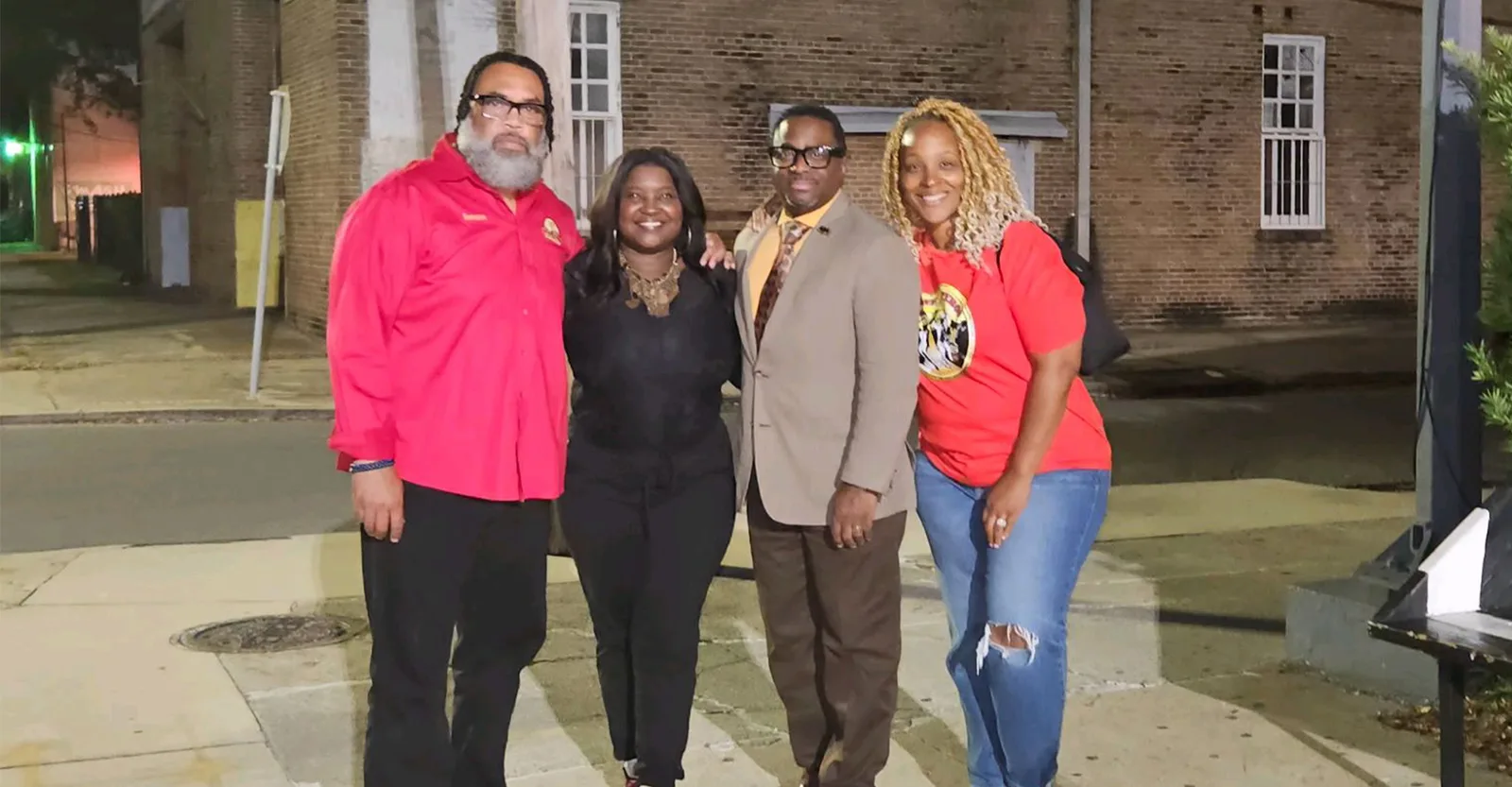 Krewe members with community partners outside an evening event in Louisiana